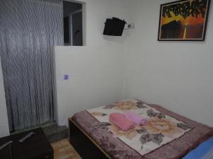 a small bedroom with a bed with flowers on it at Central Station Hostel Barcelona in Barcelona +14 photos