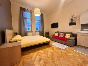 a bedroom with a large bed and a couch at Cheerful Corner in Krakow