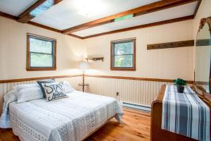 - une chambre avec un lit et 2 fenêtres dans l'établissement Amazing Views, Hot Tub, Huge Deck at Chalet Cabin, à Great Cacapon