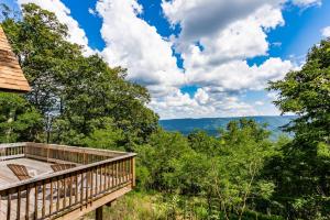 a wrap around deck with a view of the woods at 3BR cabin w scenic deck and pet-friendly in Great Cacapon