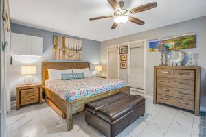 a bedroom with a bed and a ceiling fan at Waikomo Stream Villas 322 in Koloa +33 photos