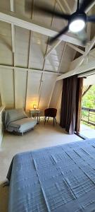 a bedroom with a bed and a table in a room at Green Villa Moorea in Temae
