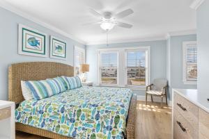 a bedroom with a bed and a ceiling fan at Poseidon in Atlantic Beach