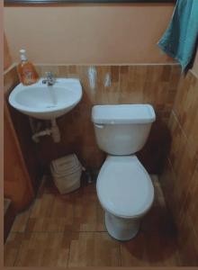 a bathroom with a white toilet and a sink at Ciudad Vieja Bed & Breakfast Hotel in Guatemala