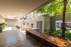 a bench in the middle of a room with trees at Triplo in Sao Paulo