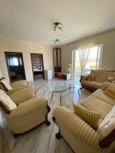 a large living room with couches and a table at Vila Mare Mateo in Ksamil