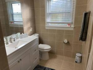 a bathroom with a sink and a toilet and a window at Renovated 3bedroom 2.5bath 2 story house w/ garage in Lawrenceville