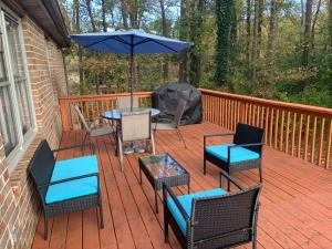 una terraza con mesa, sillas y sombrilla en Renovated 3bedroom 2.5bath 2 story house w/ garage en Lawrenceville