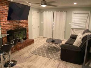 a living room with a couch and a fireplace at Renovated 3bedroom 2.5bath 2 story house w/ garage in Lawrenceville