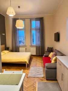 a living room with two beds and a couch at Cheerful Corner in Krakow