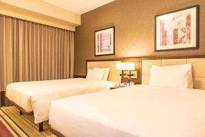Postel nebo postele na pokoji v ubytování Hotel Sunroute Plaza Shinjuku