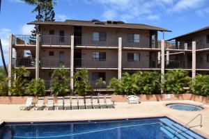 a resort with a swimming pool and a building at Kihei Alii Kai D402 in Kihei