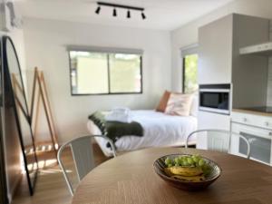 a kitchen with a table with a bowl of fruit on it at Tawonga Tourist Park in Tawonga