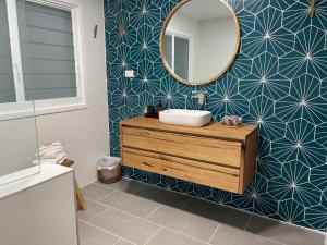 a bathroom with a sink and a mirror on a wall at 24 Hyam Rd Hyams Beach in Hyams Beach +52 photos