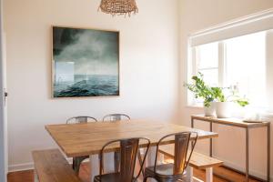 a dining room with a wooden table and chairs at Victorian Coastal in Portarlington