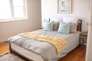 a bedroom with a bed with white sheets and pillows at Victorian Coastal in Portarlington