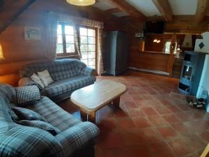 a living room with two couches and a coffee table at Luxuriöse Blockhütte mit Sauna und Whirlpool in Lachtal