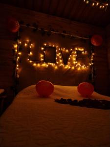 a bed with a sign that says elf with lights at Glamping entre bosques in La Calera