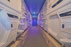 a long aisle in a locker room with sinks at Capsule Inn Bali in Legian