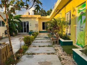 a walkway in front of a yellow building at Rústico Mayan in Cancún