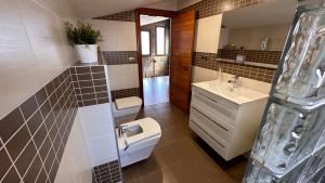 a bathroom with a toilet and a sink at Hermosa Villa L'Ardiaca in Cambrils