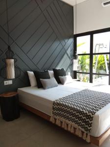 ein Schlafzimmer mit einem großen Bett mit einem großen Fenster in der Unterkunft Villa Maitreya in Uluwatu