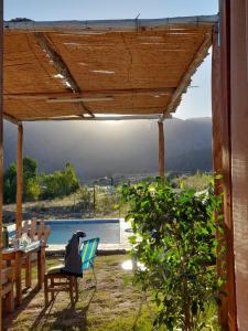 a patio with a table and chairs and a pool at El Rincon in Cacheuta