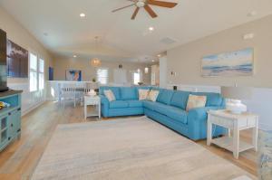 a living room with a blue couch and a kitchen at ShortWalk2 in Oak Island