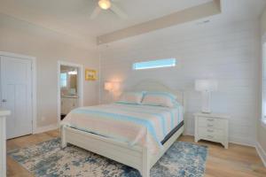 a white bedroom with a bed and a window at ShortWalk2 in Oak Island +51 photos