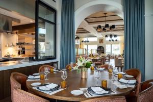 a dining room with a wooden table and chairs at The Benson Hotel & Faculty Club in Aurora