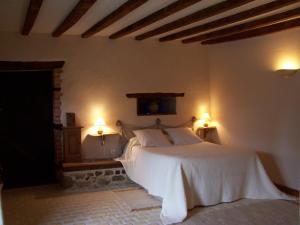 a bedroom with a white bed and two lamps at Domaine des Maillets in Blot-lʼÉglise