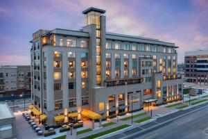 a rendering of a building on a city street at The Benson Hotel & Faculty Club in Aurora