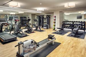 a gym with treadmills ellipticals and tread machines at The Benson Hotel & Faculty Club in Aurora