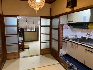 a small kitchen with a sink and a counter at Kyo Yukari in Kyoto
