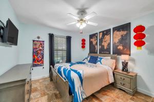 a bedroom with a bed and a ceiling fan at Verb - Arcades, Grill, Gym, Piano, Pong, & Beach! in Fort Walton Beach