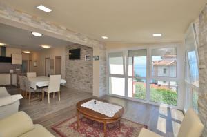 a living room with a table and a dining room at Apartments Bela in Lovran