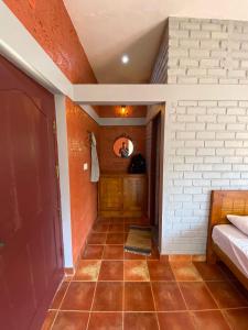 a hallway of a house with a bed and a door at FernHills Homestay in Madikeri