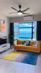 a living room with a couch and a large window at Mango House3-LuxurySweet I Biggest unit I infinity pool I Wifi-JQ in Kota Kinabalu