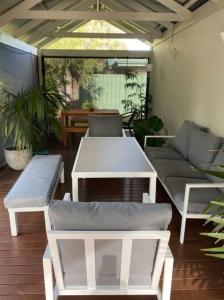 a patio with couches and a table on a patio at Salty in Quindalup +10 photos
