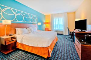 a hotel room with a bed and a desk and a television at Fairfield Inn and Suites by Marriott Durham Southpoint in Durham +20 photos