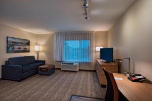 a living room with a couch and a television at TownePlace Suites by Marriott Tacoma Lakewood in Lakewood
