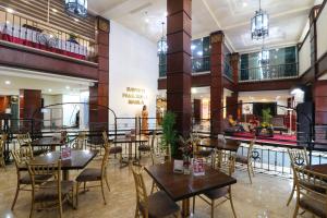 a restaurant with tables and chairs in a building at Bayview Park Hotel Manila in Manila