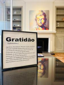 a sign in a room with a picture of a woman at Maktub Brasil - Hostal Boutique in Santiago