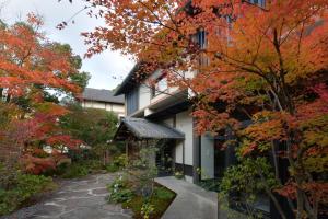 a house in the fall with colorful trees at Ryokan Sumiya Kihoan in Kameoka