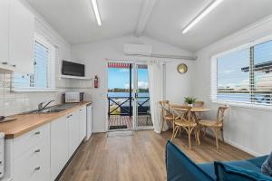 a kitchen with a table and chairs and a dining room at Camp Jordan in Port Macquarie