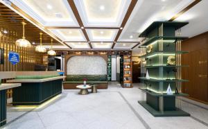 a lobby of a store with green furniture at Nostalgia Hotel S - Beijing National Convention Center in Beijing