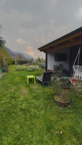a yellow bench in a yard next to a house at El Habar de Pria in La Pesa