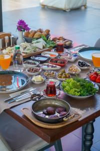 a table with many plates of food on it at Sandora Boutiuqe Hotel in Yalıkavak