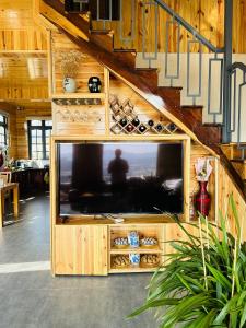 a large entertainment center with a tv in a room at Mệ Liệu's House in Da Lat