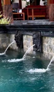 two water fountains on the side of a fountain at La Reserve 1785 Canggu Beach in Canggu